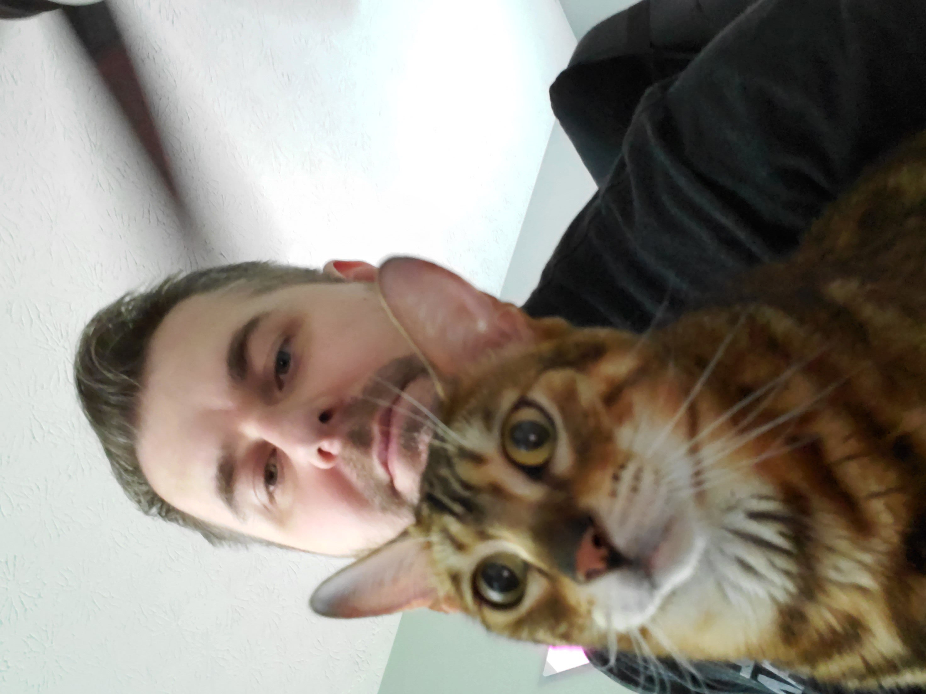 Thomas Nelson with Leo the cat in the home office